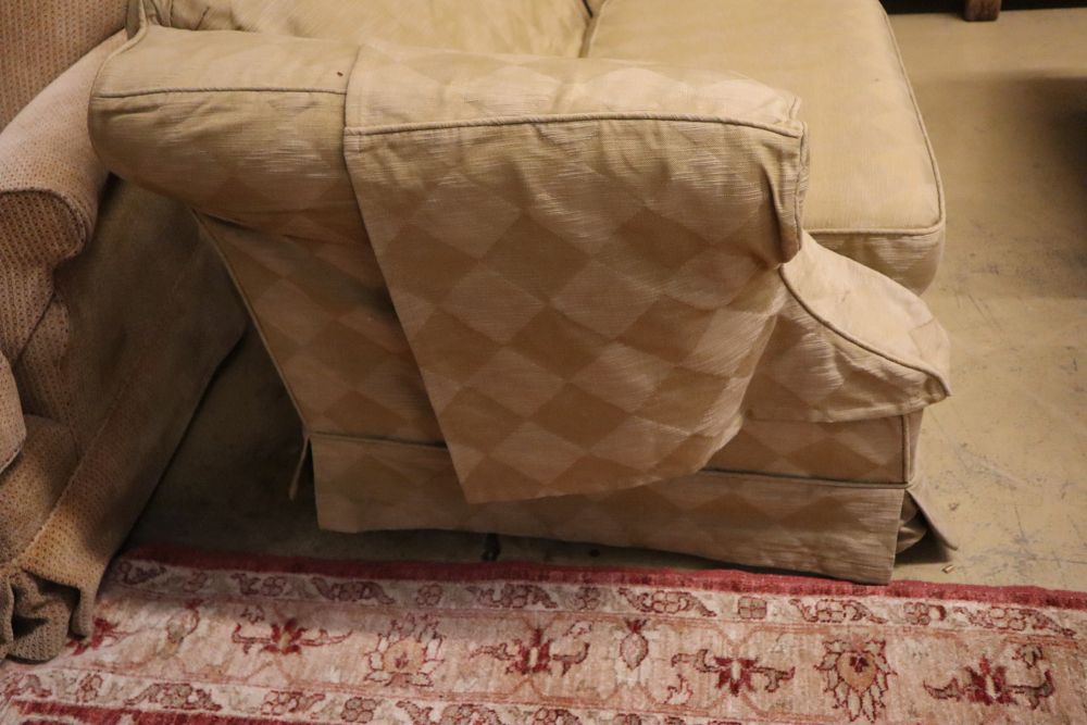 A small upholstered two seater camel back settee with loose pale green cover, length 150cm, depth 88cm, height 84cm